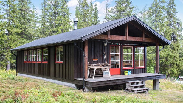 A wooden cabin with a porch, large windows, and a chimney. - Pet friendly home in Oviken with sauna (Oviken)