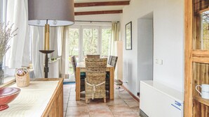 A cozy room with a large window, wicker furniture, a table with a bowl, and a lamp. - Gorgeous home in Vianden with WiFi (Vianden)