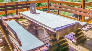 Enjoy a meal on the deck with a picnic table and bench.