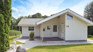 A single-story building with a sloped roof, a front porch, and a small attached garage. - Nice home in Hejls with WiFi (Hejls)