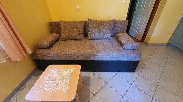 A living room with a sofa and a small table.