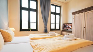 A hotel room with two beds, a TV, and a wardrobe. - Apartment Stephanie - House Prussia (Heringsdorf)