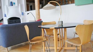 A modern dining area with a round table and four chairs, a blue sofa, and a lamp. - Beautiful home in Smålandsstenar (Smålandsstenar)