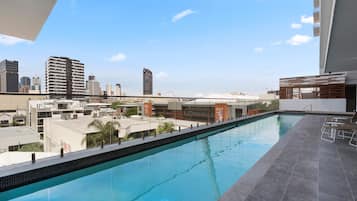 Outdoor pool, open 7 AM to 10 PM, pool loungers