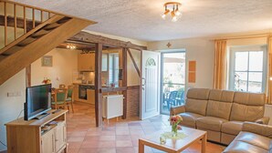 A spacious living area with a wooden staircase, a kitchen, a dining area, and a sofa. - Stunning home in Burg Reuland/Steffesh. (Burg Reuland/Steffesh.)