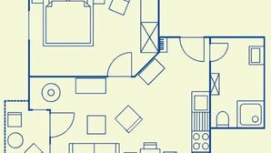 A floor plan with a kitchen, dining area, and a living room with a sofa and a TV.