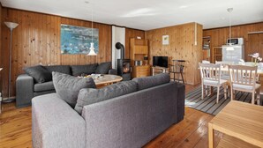 A cozy living room with a sofa, TV, and a fireplace. - Nice home in Sydals with WiFi (Sydals)