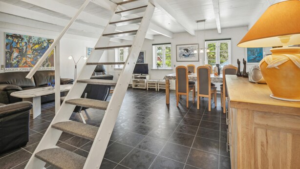 A modern interior with a spiral staircase, a dining area, and a kitchen. - Awesome apartment in Rømø with WiFi (Rømø)