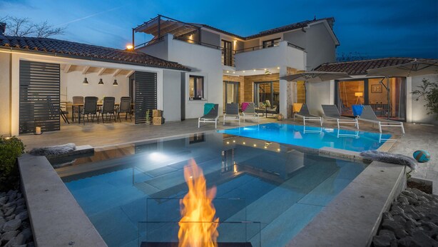 A modern house with a swimming pool, outdoor seating, and a fire feature. - Gorgeous home in Barban with sauna (Barban)