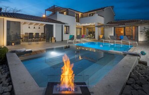 A modern house with a swimming pool, outdoor seating, and a fire feature. - Gorgeous home in Barban with sauna (Barban)