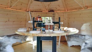 A wooden interior with a central table holding various kitchen appliances and utensils. - Lovely home in Quiestède with sauna (Quiestède)