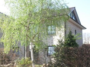 A two-story building with a stone facade and a sloped roof.