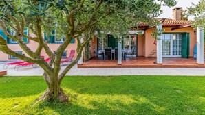 A house with a patio area, outdoor seating, and a tree in the foreground. - Stunning home in Pula (Pula)