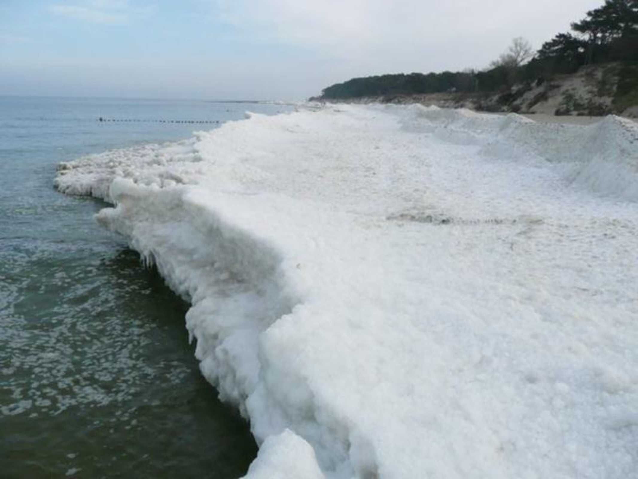 A coastal scene with a frozen shoreline.
