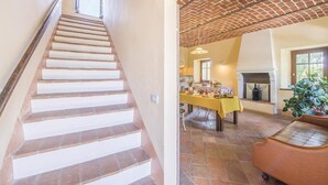 A staircase leading to a dining area with a brick ceiling and a fireplace. - Beautiful home in Aramengo (AT) (Aramengo (AT))