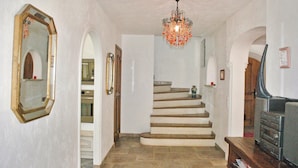 A hallway with a staircase, a chandelier, and a fireplace. - Amazing home in Callian (Callian)