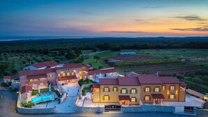 A large, multi-story hotel with a swimming pool, surrounded by landscaped gardens and vineyards. - Beautiful apartment in Hr-52215 Vodnjan (Hr-52215 Vodnjan)
