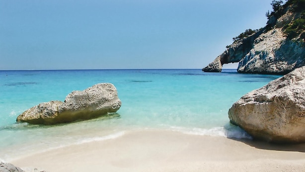 A beach with clear turquoise water, large rocks, and a sandy shore. - 6 bedroom beautiful home in Orosei NU (Orosei NU)