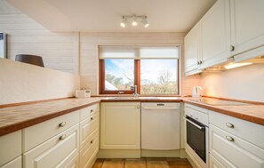 Fridge, stovetop, dishwasher, coffee/tea maker