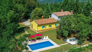 A two-story house with a swimming pool, surrounded by trees and a hilly landscape. - Beautiful home in Nedescina (Nedescina)