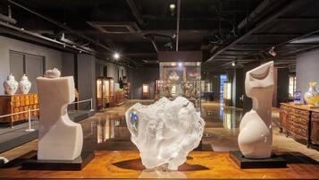 A modern art gallery with sculptures and decorative vases on display.