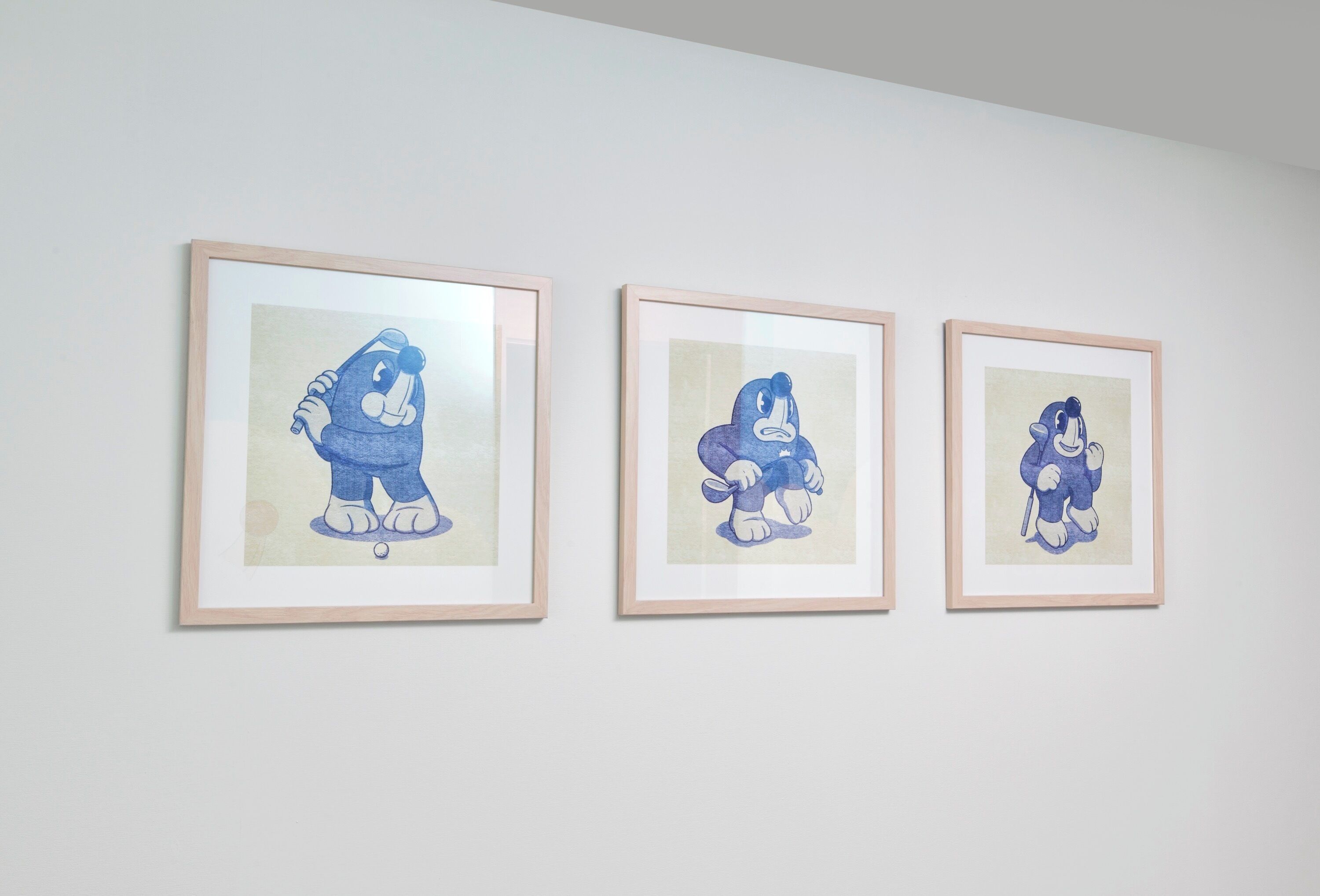 Three framed artworks on a wall.