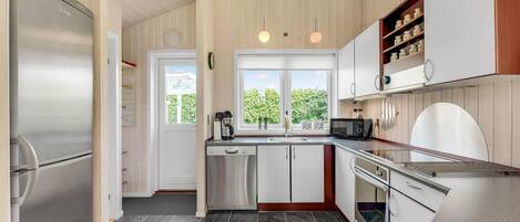 Fridge, stovetop, dishwasher, coffee/tea maker