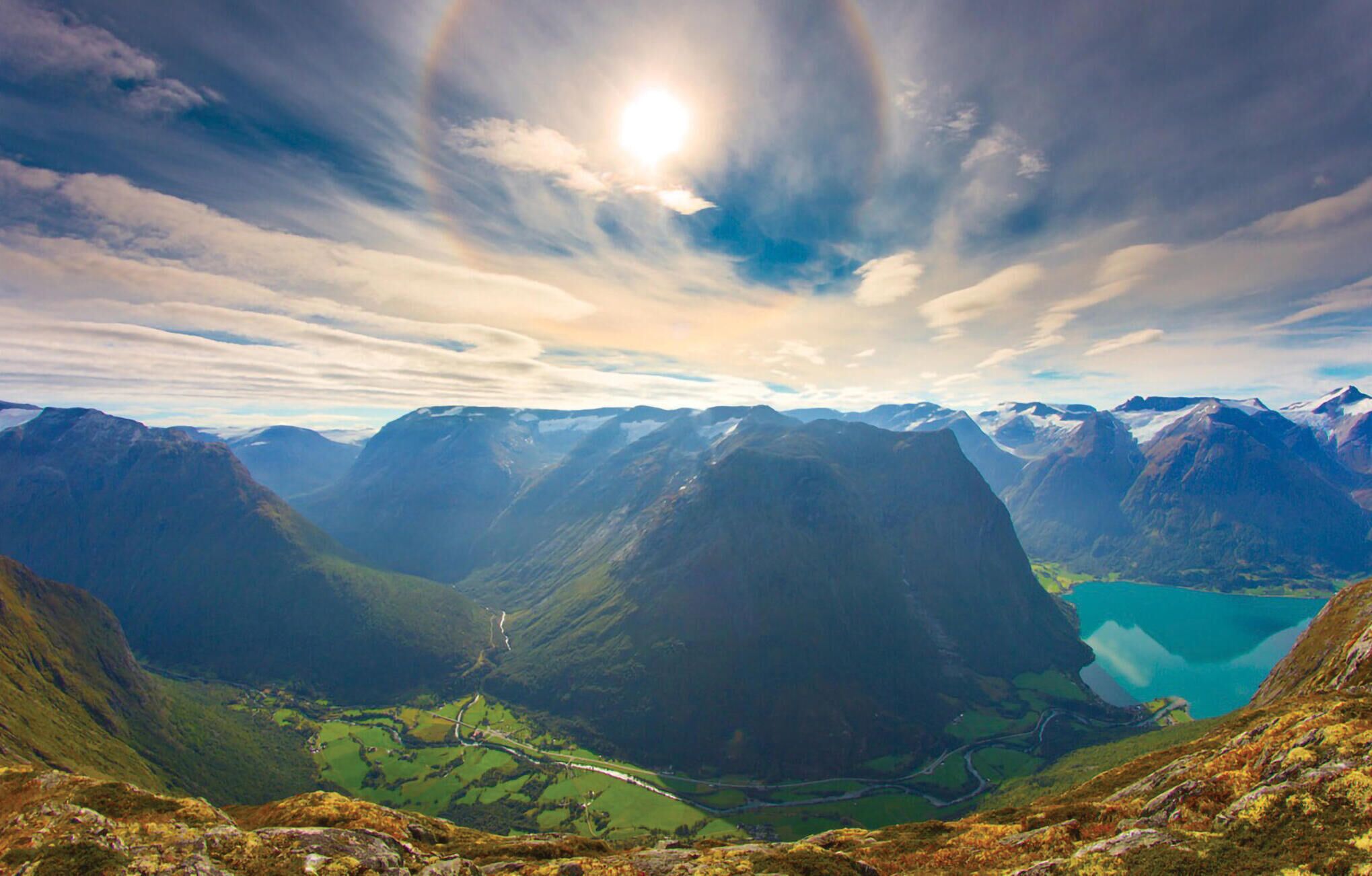 A mountainous landscape with a valley and a lake.