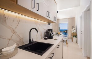 Fridge, stovetop, dishwasher, coffee/tea maker