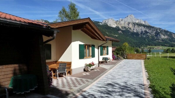 A house with a patio, outdoor seating, and a mountain view.