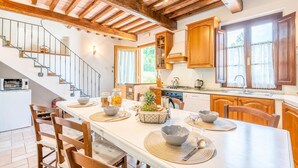 A spacious kitchen with wooden cabinets, a built-in oven, and a large window. - Nice home in Camaiore LU (Camaiore LU)