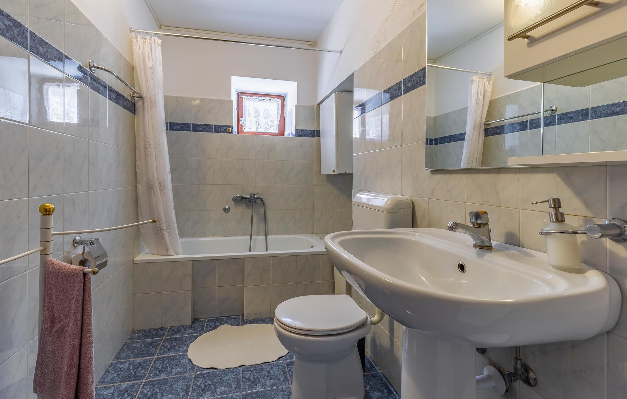 A bathroom with a bathtub, a sink, and a toilet.