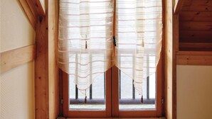 A window with wooden frames and a view of the outside. - 2 bedroom awesome home in Brucheville (Brucheville)