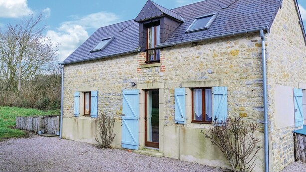 A stone house with a sloped roof, two skylights, and shutters on the windows. - 2 bedroom awesome home in Brucheville (Brucheville)