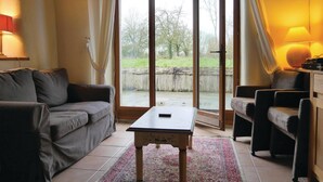 A living room with a sofa, armchair, and a small table. - 2 bedroom awesome home in Brucheville (Brucheville)