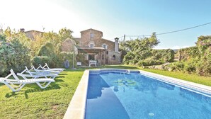 A stone building with a pool and white lounge chairs. - Gorgeous home in Calonge (Calonge)