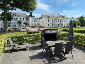 An outdoor seating area with a grill named "Villa Anna."
