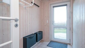 A wooden interior with a sliding glass door leading to an outdoor area. - Gorgeous home in Løkken with sauna (Løkken)