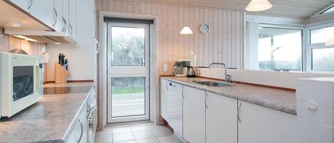 Fridge, stovetop, dishwasher, coffee/tea maker