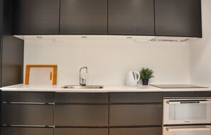Fridge, stovetop, dishwasher, coffee/tea maker