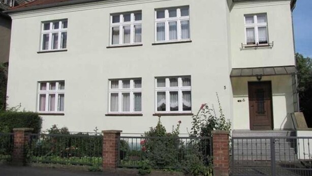 A two-story house with a flat roof, multiple windows, and a front door. - Apartment Hannah (Neubrandenburg)