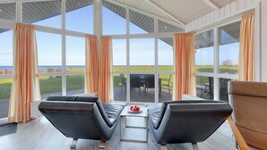 A spacious room with large windows, a wooden ceiling, and a view of a green landscape. - Amazing home in Schönhagen with sauna (Schönhagen)
