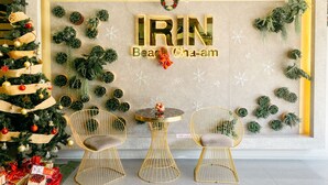 A decorated interior with a Christmas tree, gold chairs, and a wall with the text "IRIN Beach Cha-am". - Irin Beach Cha - am (Cha-am)
