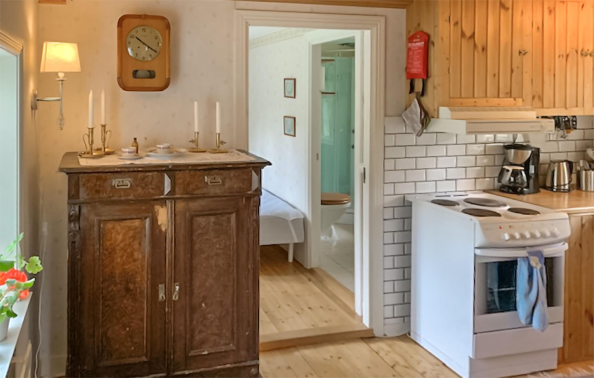 A kitchen with a wooden cabinet, a stove, and a sink.