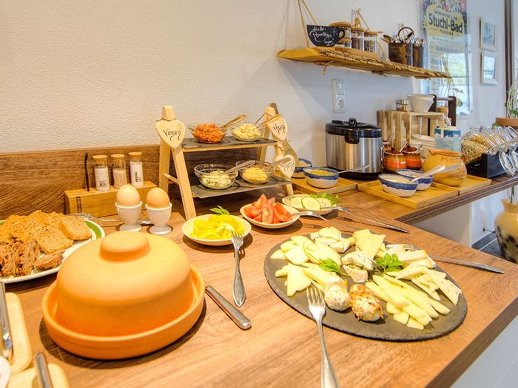 A buffet with various food items and utensils.
