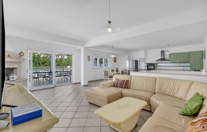 Relax in this inviting living area with a comfortable sofa and dining space, perfect for meals and socializing.
