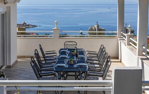 Enjoy a meal on the terrace with a stunning coastal view.
