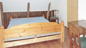 A wooden bed with a blue mattress and a wooden headboard. - 2 bedroom cozy home in Mörbylånga (Mörbylånga)