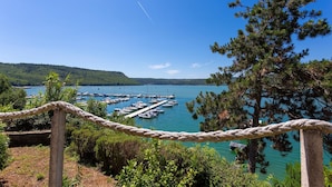 A marina with boats docked, surrounded by greenery and a clear sky. - 3 bedroom amazing home in Trget (Trget)