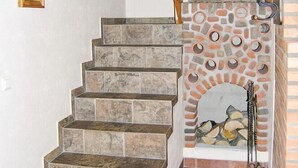 A staircase with stone steps leading to a wooden ceiling and a stone wall with a fireplace. - Amazing home in Ljungsarp with sauna (Ljungsarp)